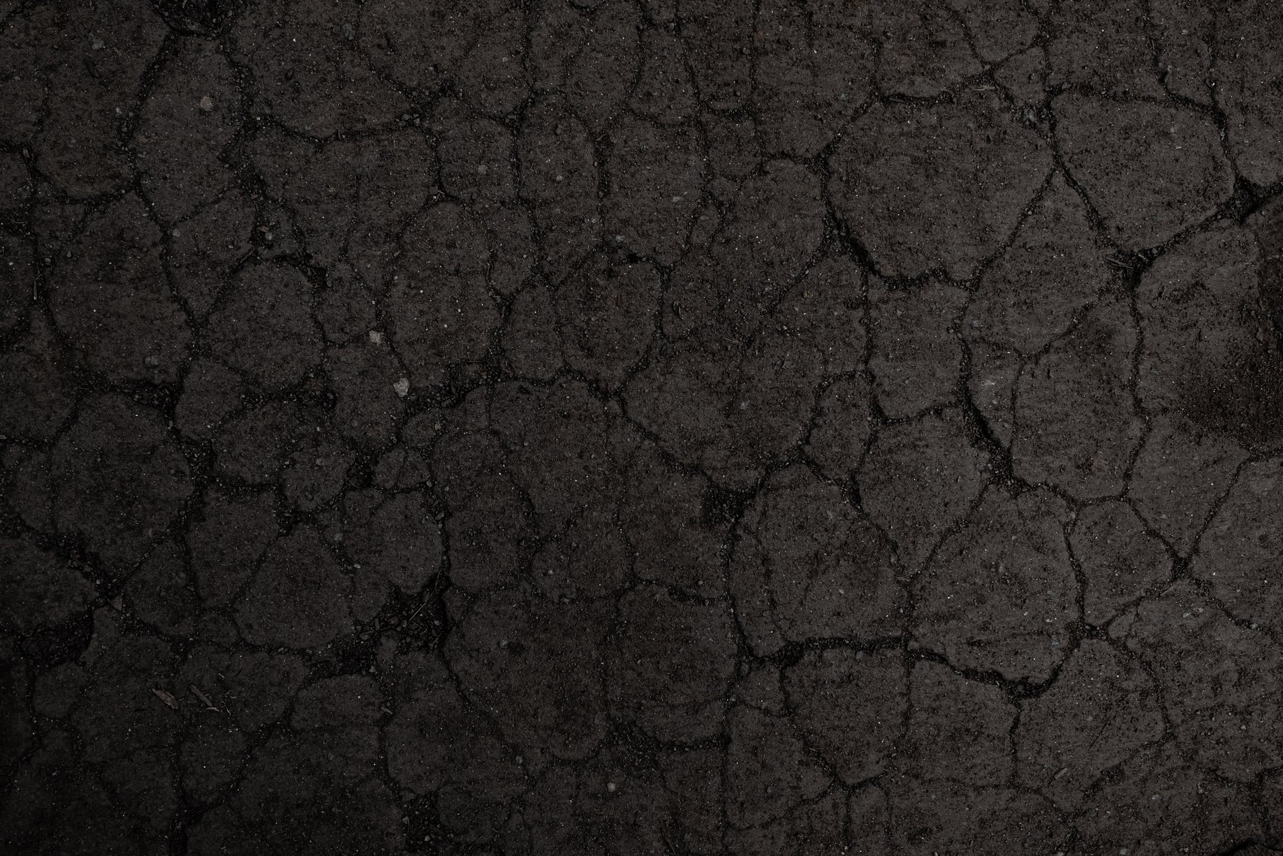 Black cracked soil texture background